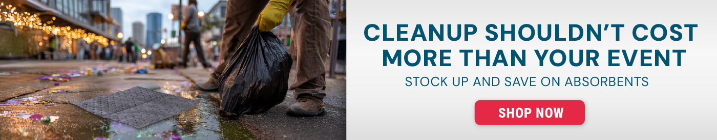 Worker wearing gloves lifting a black trash bag from a wet pavement surface with absorbent pads on the ground. Text reads “Cut Down on Cleanup Costs. Stock Up and Save on Absorbents” with a Shop Now button.